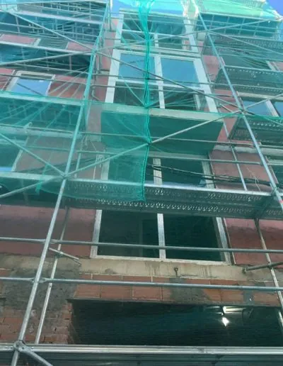 Andamiada de un edificio con la carpintería de aluminio instalada