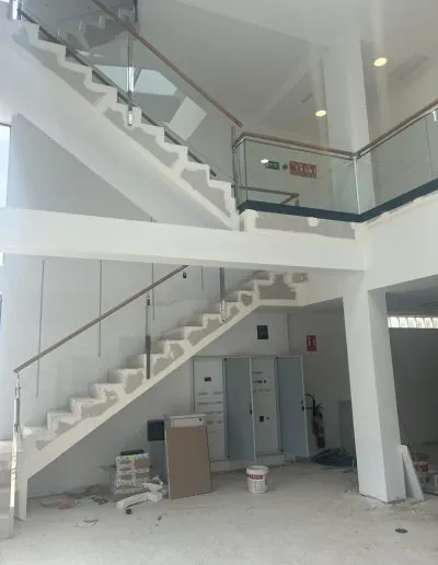 Escalera con barandilla de cristal en un edificio en obra
