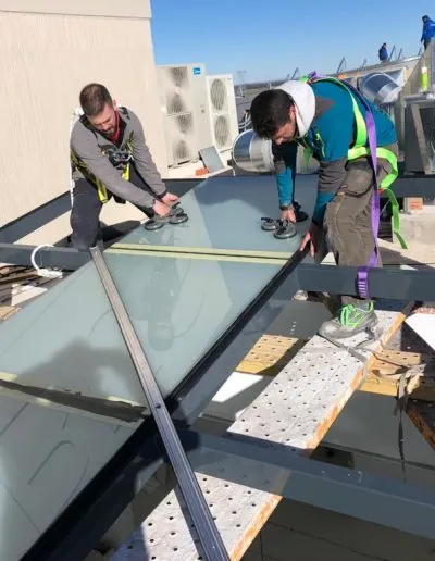 Operarios colocando un cristal en una cubierta